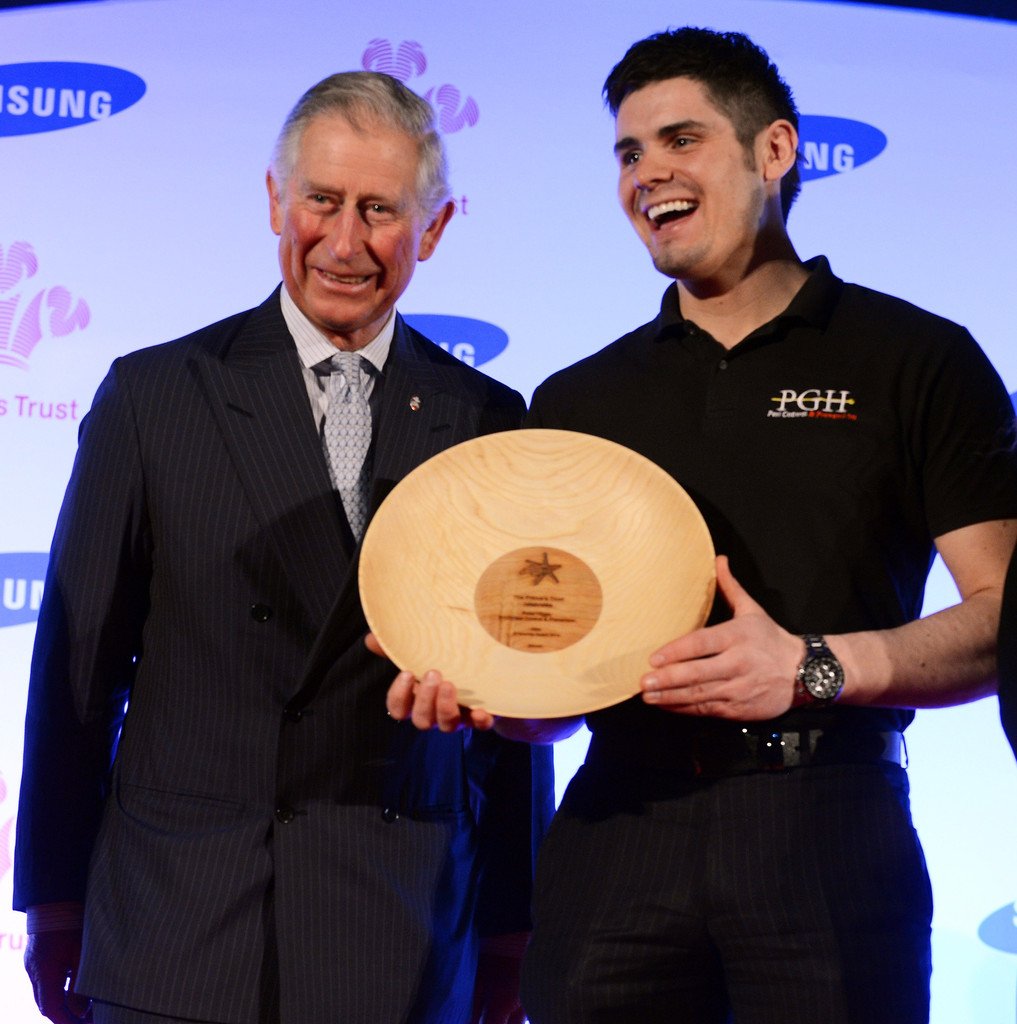 The group's founder receiving the Prince's Trust Success Award — Gold from the then Prince of Wales, now His Majesty King Charles III